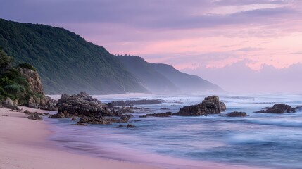 Serene Coastal Scenery with Lush Green Hills Sandy Beach and Rocky Outcrops Under a Pastel Colored Sky in Soft Lighting with Mist and Calm Waters