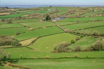 A northward view from Carreg Cennen Castle in Carmarthenshire, Wales, overlooking a rural landscape of rolling green fields