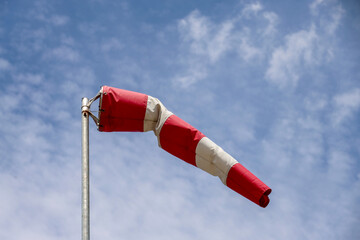 Wind sock in red and white colors to indicate wind speed and direction
