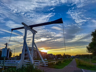Sunset over Nieuwerkerk aan den IJssel with wooden drawbridge in ring