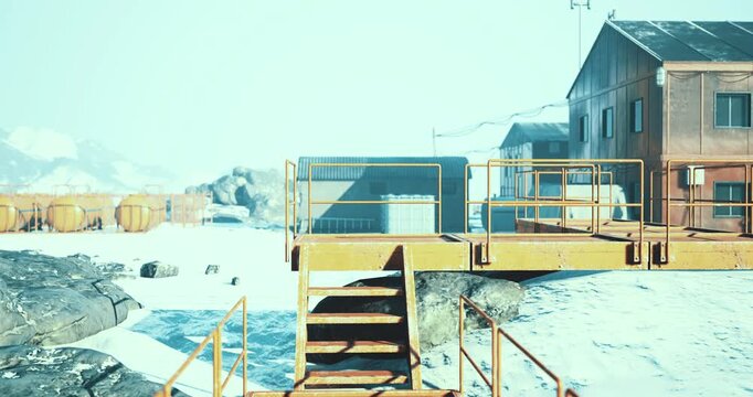 Amidst a pristine snowy landscape, an Arctic research station stands resilient. The structures are surrounded by icy terrain, with orange scaffolding hinting at ongoing operations in the cold.
