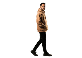 Naklejka premium Hispanic man in oversize hoodie walking with hand in pocket
