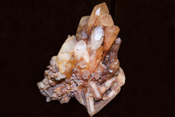 Quartz with white and brown crystals on a dark background. Gems, mineralogy, jewelry.