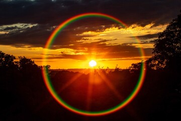 Vibrant Sunset with Rainbow Lens Flare. Circular rainbow in a ring