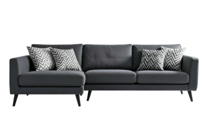 Modern gray sectional sofa with two chevron pillows on a dark, isolated background
