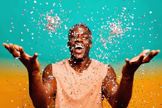 Funny African American man throwing confetti in the air isolated on blue