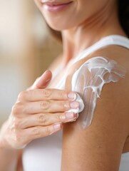 Woman Applying Moisturizer on Shoulder - Skincare Routine and Beauty Concept