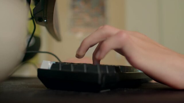 Focused fingers on compact keyboard, Detailed shot of fingers typing in quiet late afternoon light, Intimate view of hands hitting keys on small keyboard amid calm workspace