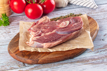 Raw lamb steak with bone