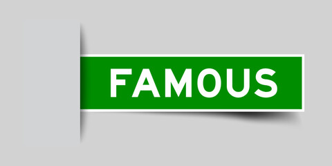 Green color square shape sticker label with word famous inserted in gray background