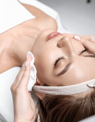 Woman receiving professional facial treatment at a spa.