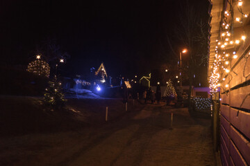 Magical Christmas village illuminated at night with festive lights