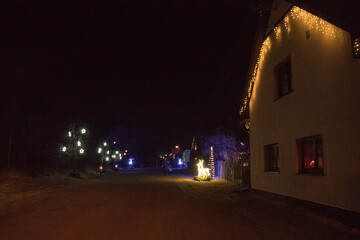 Magical Christmas village illuminated at night with festive lights