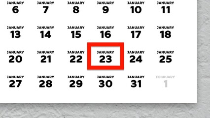 Close-up of the date January 23rd marked with a red cursor on the wall calendar 2026