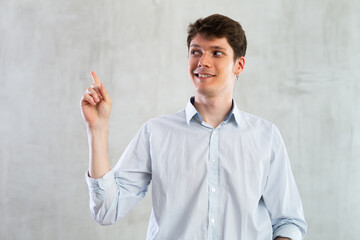 Positive man pointing with his hand at something - advertising concept