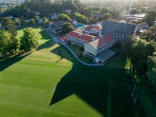 Naklejka premium Aerial view of Dilworth School, a boarding school for boys in Auckland, New Zealand. The photo shows the school buildings and sports fields on a sunny day.