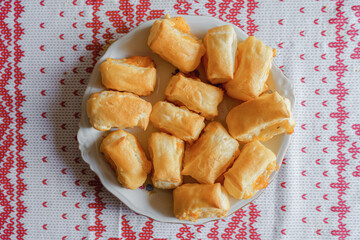 Assortment of freshly baked homemade cheese puff pastries on wood