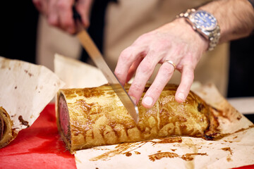 close up of hands holding a wedding cake
