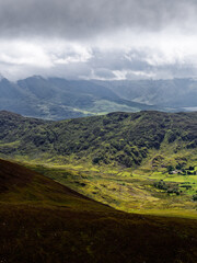 Dramatic interplay of light and shadow across mountain ridges. The varied textures and cool tones enhance the mood, creating a captivating vista.