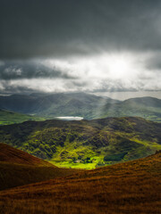 Viewing moody landscape in Killarney National Park with green mountains and a distant lake.