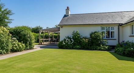 Charming rural home with lush green garden and inviting outdoor pergola dining area under clear