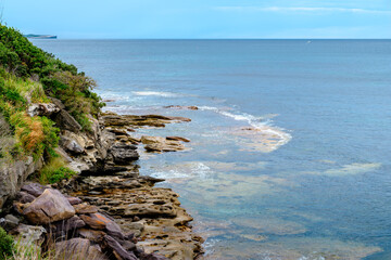 Taken at Hungry Point Reserve on the Cliff Top Walk in December 2025, this photo shows the coastline views toward Bundeena and Maianbar, with people enjoying hiking and coastal life.