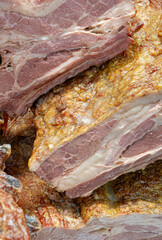 Smoked pork belly or brisket on the counter of a butcher shop