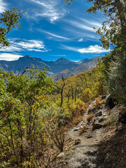 Scenic view of the winding Vereda de la Estrella trail leading towards the snowy Mulhacen and Alcazaba mountains in the beautiful Sierra Nevada National Park, Andalusia, Southern Spain.