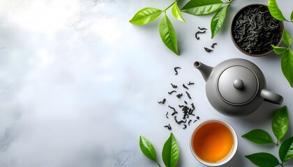 Minimalist background with tea leaves, a teapot, and a cup of tea