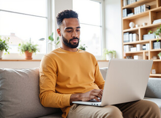 Black Male Freelancer Working on Laptop at Home – Modern Home Office Setup for Remote Work Concepts and Digital Nomad Lifestyle