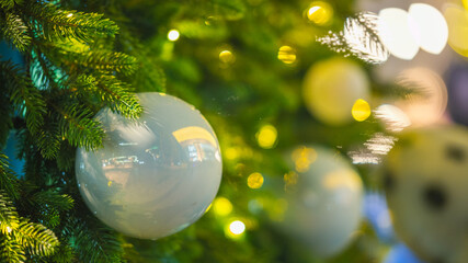 Christmas tree with white and blue ornaments and warm festive lights