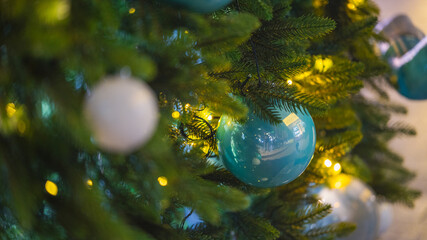 Christmas tree with white and blue ornaments and warm festive lights