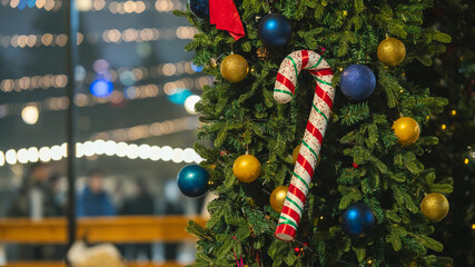 Christmas candy cane ornament on decorated Christmas tree