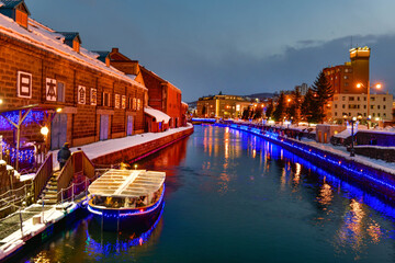 Otaru water canal and buildings along the waterfront outdoor in winter at nightime in Hokkaido , Otaru, Japan
