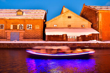 Otaru water canal and buildings along the waterfront outdoor in winter at nightime in Hokkaido , Otaru, Japan