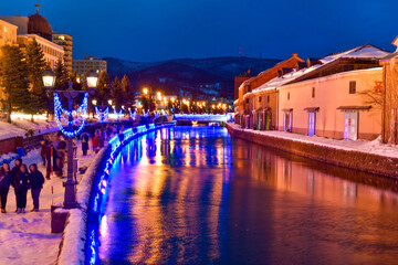 Otaru water canal and buildings along the waterfront outdoor in winter at nightime in Hokkaido , Otaru, Japan