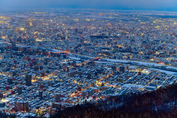 Night view of Sapporo cityscape in winter at twilight from Mt. Moiwa observation, the best city view point, Sapporo, Hokkaido, Japan