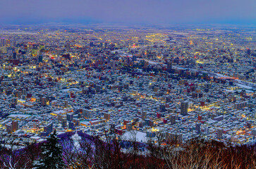 Night view of Sapporo cityscape in winter at twilight from Mt. Moiwa observation, the best city view point, Sapporo, Hokkaido, Japan