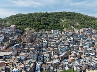 Aerial drone view of Favela Of Cantagalo, Rocinha favelas spread out on the mountain in Sao Conrado , Rio de Janeiro, Brazil.