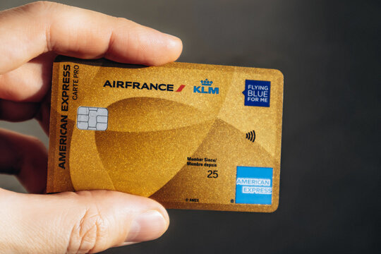 Nice, France - December 9, 2025: Man holding American Express Air France KLM Business credit card in hand, close-up