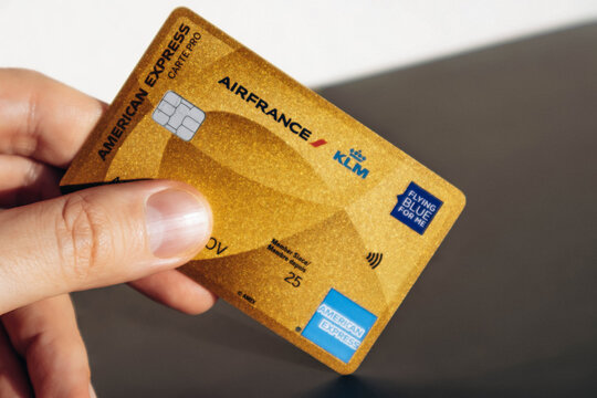 Nice, France - December 9, 2025: Man holding American Express Air France KLM Business credit card in hand, close-up