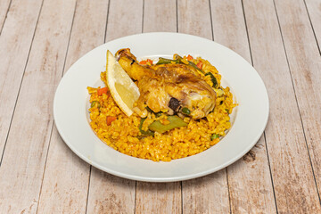 Traditional Valencian paella in its steel paella pan, with golden rice, chicken, rabbit, green...