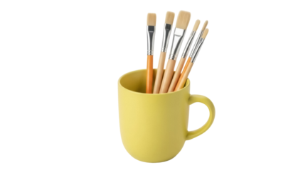 Isolated mustard mug with paintbrushes, art tools for drawing and painting supplies