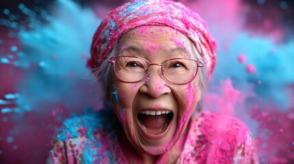 This spirited elderly woman bursts with joy as she joyfully celebrates, covered in vibrant colored powders, radiating happiness and energy in a colorful atmosphere.
