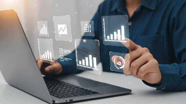 A young adult male figures managing digital data analytics and business metrics while using a laptop in a modern office environment, emphasizing tech proficiency and analysis skills.