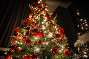 Christmas tree adorned with vibrant red ornaments and twinkling lights, creating a festive atmosphere, capturing the essence of holiday celebrations and joy