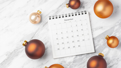 December calendar with gold christmas ball decoration on marble table background