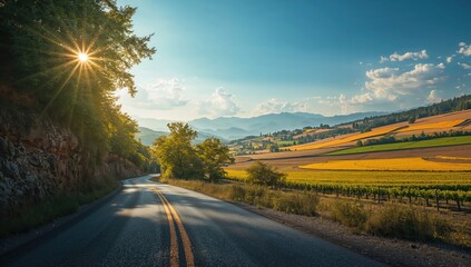 Mountainous landscape with a curving rural road descending into a deep valley, highlighting topography