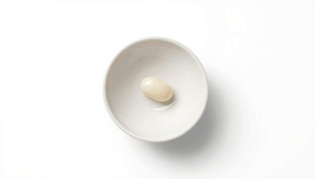 White kidney beans presented in a plain white ceramic bowl, highlighting plant-based protein sources