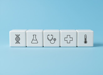 White cube blocks with medical icons on blue background for healthcare and science concept. Symbol of medicine and biotechnology.